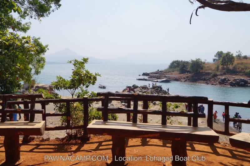 Scenic view of Pawna Lake with boats and a clear sky from Lohagad Boat Club.