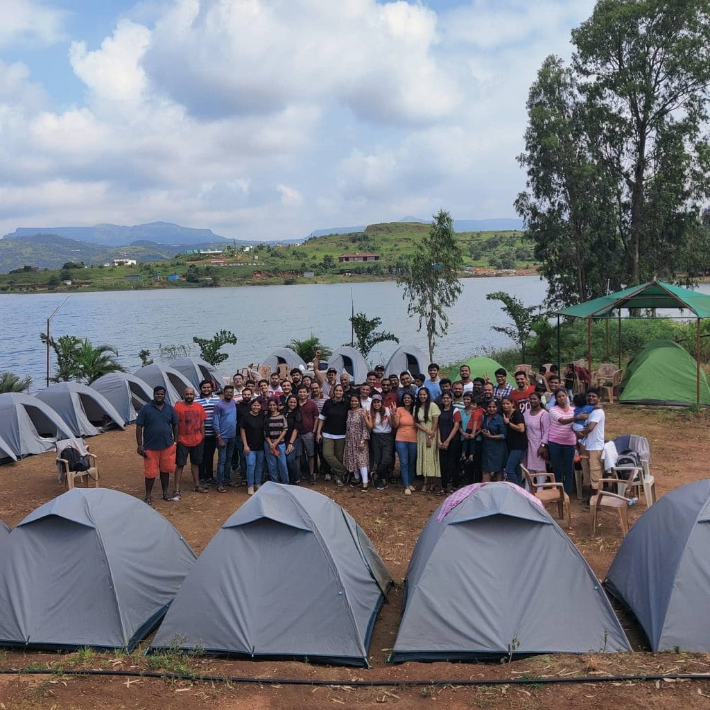 A large group enjoying a lakeside camping outing